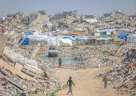 boys walk past the rubble of destroyed buildings in the jabalia camp for palestinian refugees in the northern gaza strip photo afp