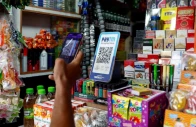 a man uses his phone to scan a qr code of the digital payment app paytm after purchasing a cold beverage at a shop in kolkata india on july 9 2024 reuters