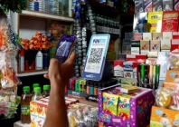 a man uses his phone to scan a qr code of the digital payment app paytm after purchasing a cold beverage at a shop in kolkata india on july 9 2024 reuters