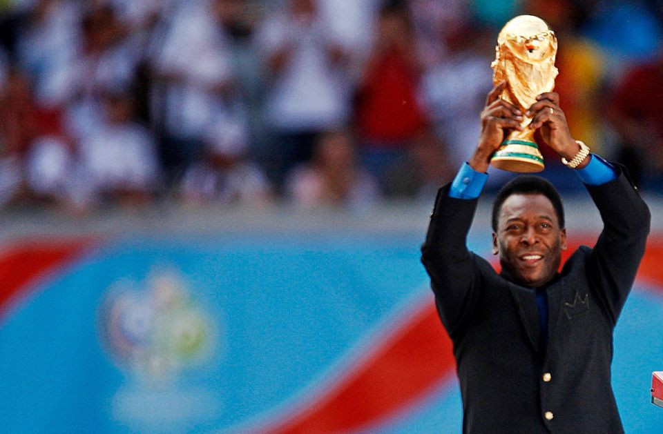 brazilian soccer legend and member of the 1958 1962 and 1970 world cup winning brazilian soccer teams pele holds the world cup trophy during the world cup 2006 opening ceremony in munich germany june 9 2006 photo reuters file