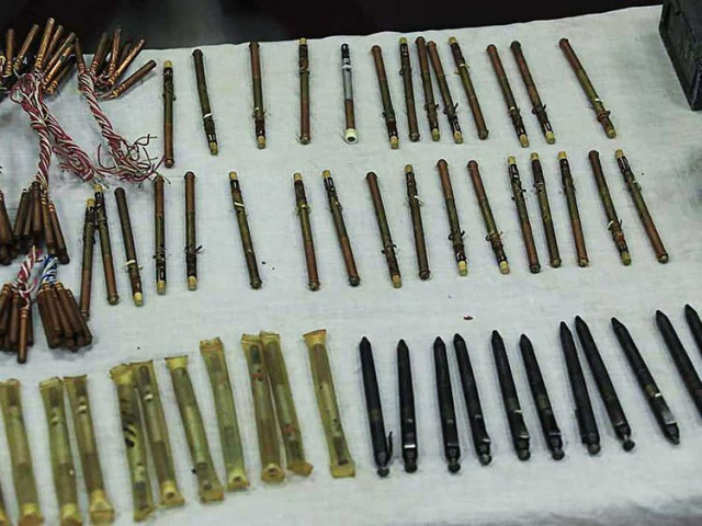 in this handout photograph taken on september 19 2020 and released by afghanistan s ministry of interior affairs moi a stash of pen guns and sticky bombs are displayed by officials following a police forces operation in a residential house in kabul afp