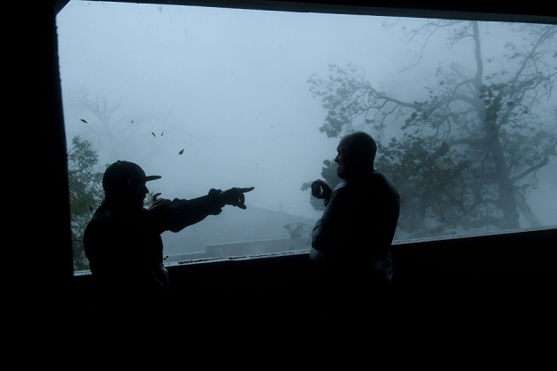 People watch as Hurricane Michael makes landfall. PHOTO AFP