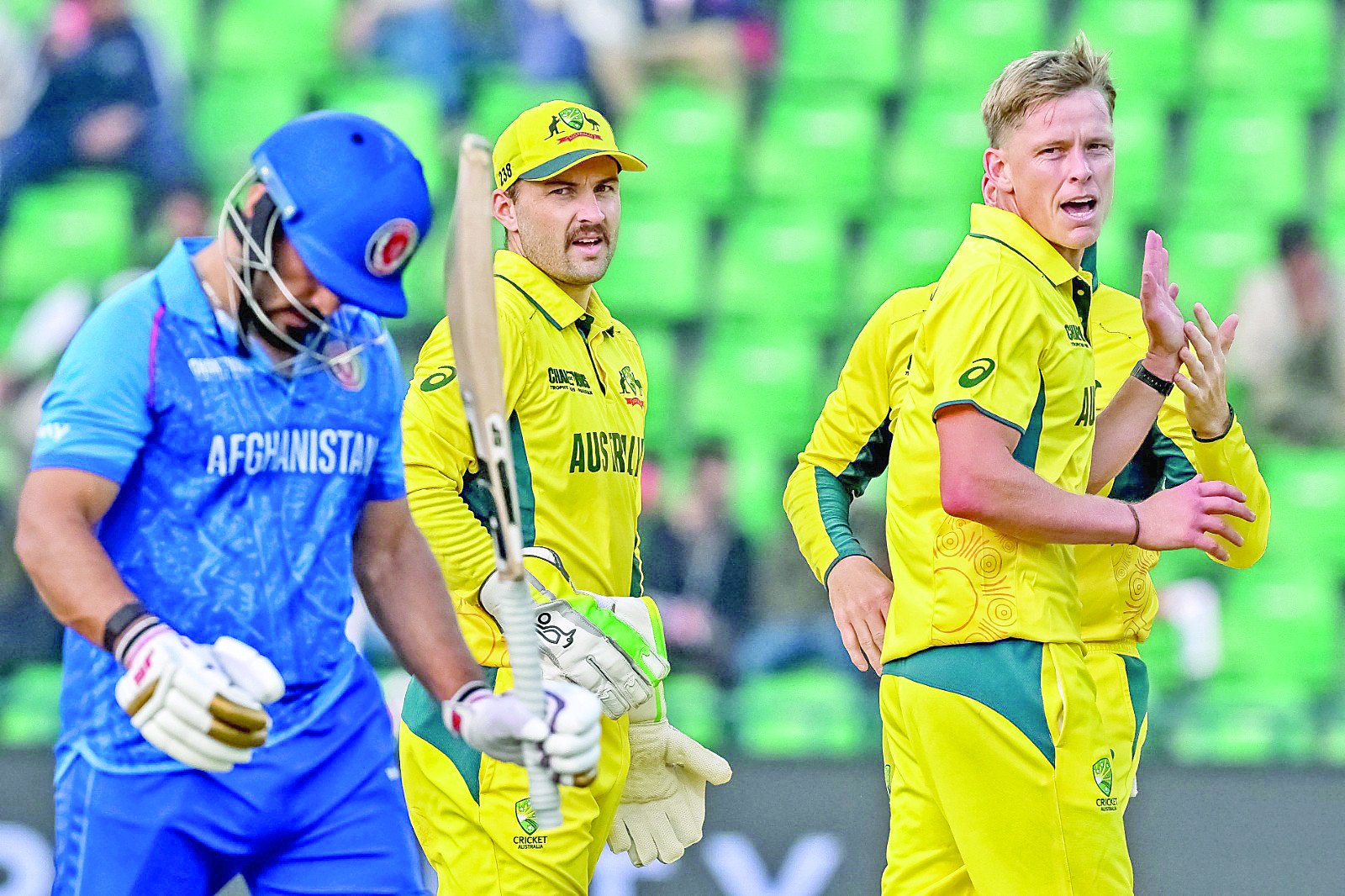 australia s nathan ellis r celebrates with teammates after dismissing afghanistan s gulbadin naib l in the icc champions trophy match at gaddafi stadium on friday photo afp