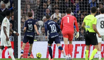 stunned celta vigo s swedish attacker williot swedberg scores his team s second goal in the win over real madrid at the bernabeu photo afp