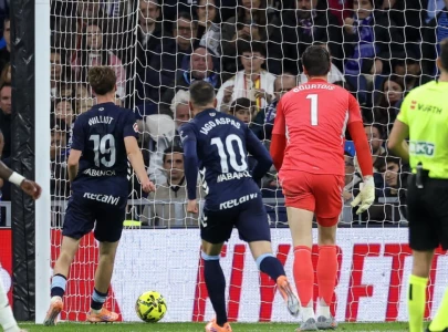 stunned celta vigo s swedish attacker williot swedberg scores his team s second goal in the win over real madrid at the bernabeu photo afp