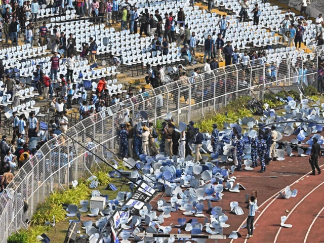 fans threw chairs onto the track of a stadium in kolkata following an appearance of football star lionel messi photo afp fans threw chairs onto the track of a stadium in kolkata following an appearance of football star lionel messi photo afp