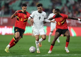 egypt s forward salah mohsen centre fights for the ball with angola s defender david carmo left and angola s defender kialonda gaspar right during the africa cup of nations photo afp
