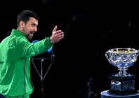 novak djokovic looks at the australian open s norman brookes challenge cup after losing in the final to carlos alcaraz photo afp
