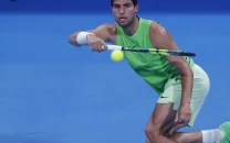 alcaraz battles into second round