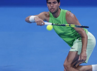 alcaraz battles into second round