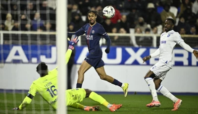 paris saint germain forward bradley barcola c was twice thwarted by auxerre goalkeeper donovan leon l in the first half photo afp