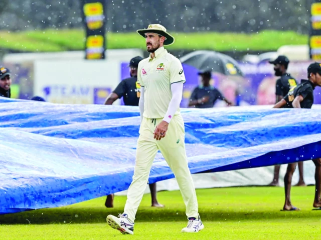 mitchell starc walks off in the rain as the covers come on photo afp mitchell starc walks off in the rain as the covers come on photo afp