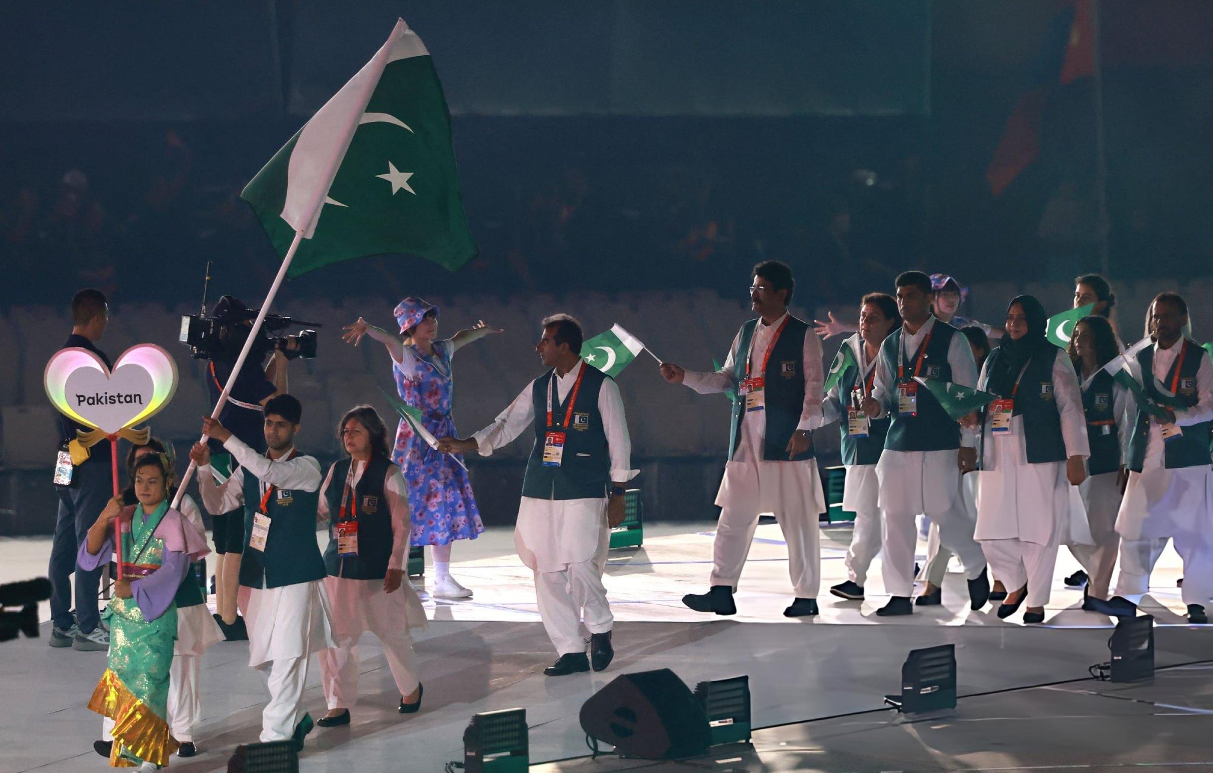 Members of Pakistan's contingent wave national flag during a march-past at the opening ceremony of the 20th Asian Games at Nagoya. Photo: AFP