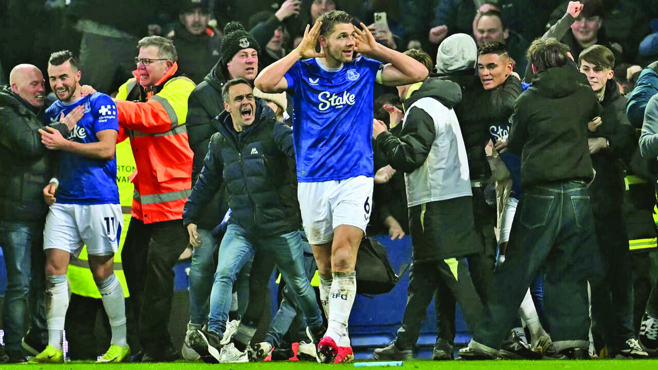 james tarkowski is mobbed by fans as he celebrates scoring everton s second goal photo afp