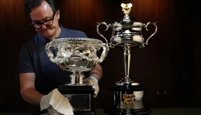 darren may general manager at w j sanders poses with the australian open 2026 norman brookes challenge cup and daphne akhurst memorial cup in sydney australia photo reuters