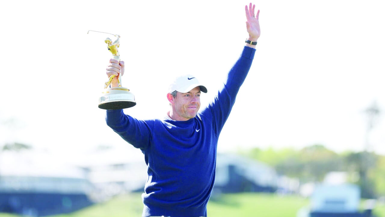 rory mcilroy celebrates with the trophy after winning the playoff at the players championship photo afp