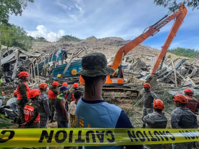 At least two dead as garbage landslide buries dozens in central Philippines