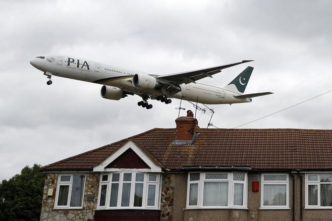 a pakistan international airlines pia boeing 777 comes in over houses to land at heathrow airport in west london on june 8 2020 photo afp