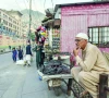 a man sits pensively along a roadside in muzaffarabad as the city settles back into its rhythm following the end of demonstrations photo afp