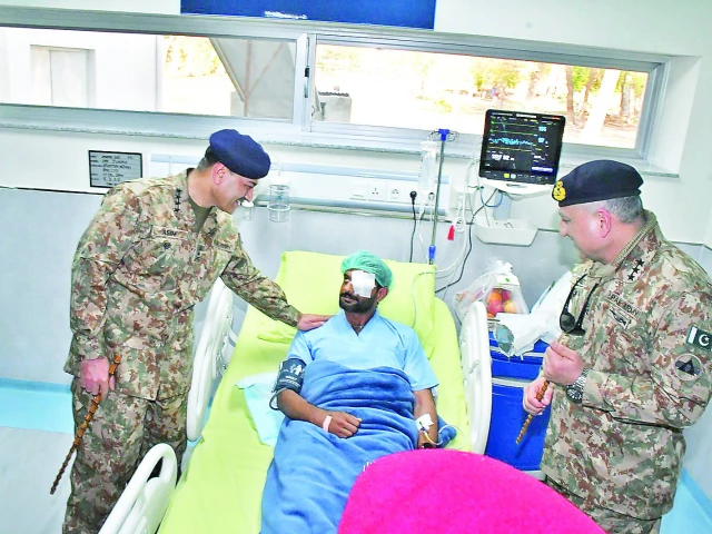 army chief gen asim munir enquires after the health and well being of an injured soldier during his visit to the combined military hospital in bannu photo app army chief gen asim munir enquires after the health and well being of an injured soldier during his visit to the combined military hospital in bannu photo app