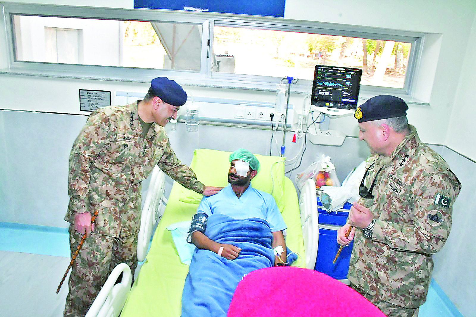 army chief gen asim munir enquires after the health and well being of an injured soldier during his visit to the combined military hospital in bannu photo app