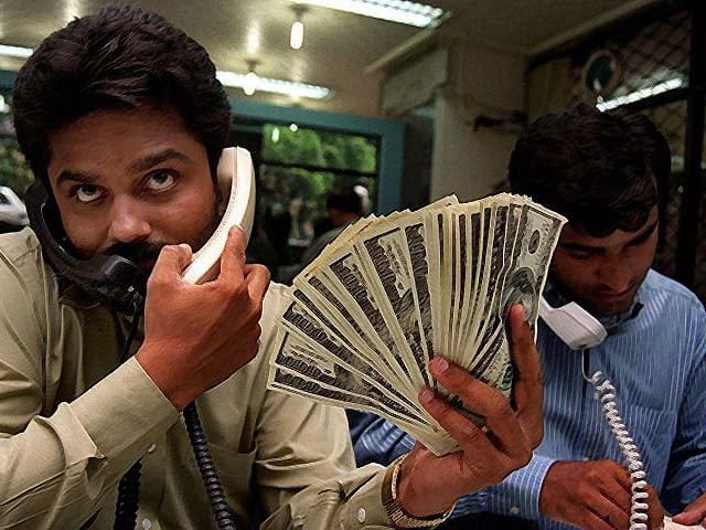 pakistani money dealers busy on their telephones photo afp