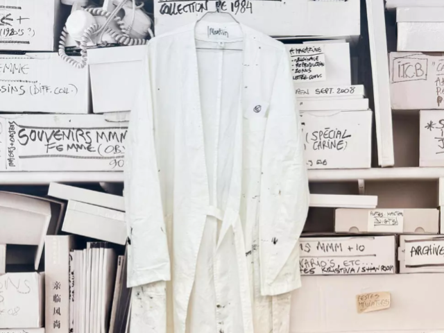 Photo: Martin Margiela's work overcoat with his name written inside during an exhibition of his belongings/AFP