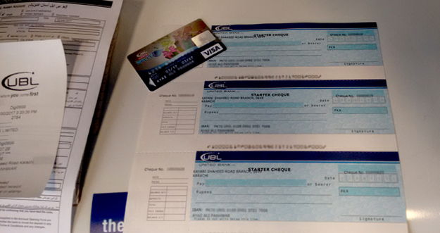 Pre-activated cheques and debit card issued to customer. PHOTO: UBL