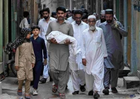 a man carries the body of a newborn who died in the pims hospital fire during the funeral in rawalpindi photo afp