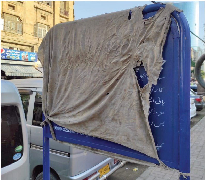 parking space contractor has put a cloth over the signboard showing official rates for parking photo razak abro express