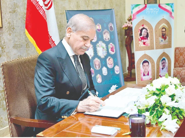 prime minister shehbaz sharif signs a condolence book at the iranian embassy expressing solidarity after the israeli aggression photo ppi