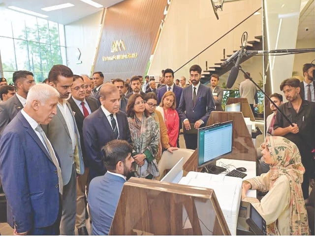 prime minister shehbaz sharif interacts with a staffer at the board of investment s first business facilitation centre in islamabad a step aimed at making it easier to do business in pakistan photo nni