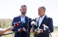 polish prime minister donald tusk speaks to the press while with defence minister wladyslaw kosiniak kamysz near a crater in a field left by an unidentified object that appears to be a russian missile polish prime minister donald tusk said on thursday near the village of tarnawa kolonia in lublin province poland july 30 2026 reuters