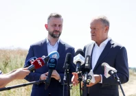 polish prime minister donald tusk speaks to the press while with defence minister wladyslaw kosiniak kamysz near a crater in a field left by an unidentified object that appears to be a russian missile polish prime minister donald tusk said on thursday near the village of tarnawa kolonia in lublin province poland july 30 2026 reuters