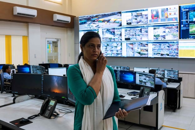 Kamal Shekhawat, head of the female police patrol unit, talks on the phone while standing inside the police command centre at the Jaipur Commissionate Headquarters in the Indian city of Jaipur. All-female police units are shaking up the male-dominated force in conservative northwest India, hitting the streets to combat sex crimes and a pervasive culture of silence around rape. PHOTO: AFP