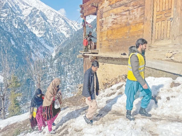 workers walk on snow during a polio vaccination drive in ajk s neelum valley photo afp workers walk on snow during a polio vaccination drive in ajk s neelum valley photo afp