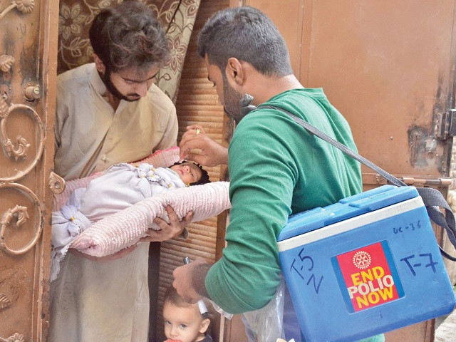 a health worker administers vaccine drops to an infant during the ongoing anti polio drive in rawalpindi photo online