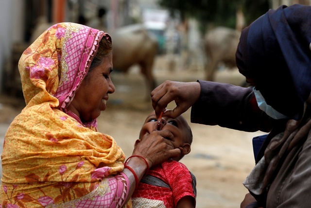 a boy receives polio vaccine drops during an anti polio campaign in a low income neighborhood as the spread of the coronavirus disease covid 19 continues in karachi