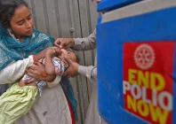 a health worker administers polio vaccine drops to a child during a door to door polio vaccination campaign photo afp