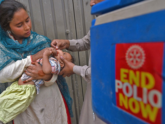 a health worker administers polio vaccine drops to a child during a door to door polio vaccination campaign photo afp