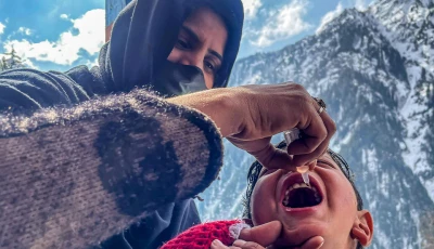 a health worker administers polio drops to a child during a door to door vaccination campaign amidst heavy snow in the bakwali surgan area of azad jammu kashmir s neelum valley on february 4 2025 afp