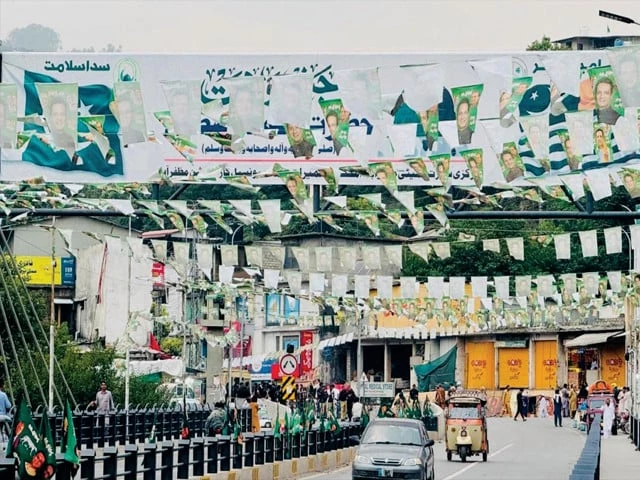 poll frenzy election banners line a road in muzaffarabad ahead of voting photo express poll frenzy election banners line a road in muzaffarabad ahead of voting photo express