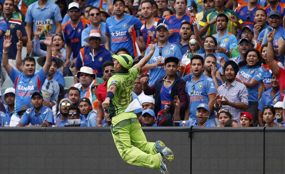 Yasir Shah leaps into the air during an unsuccessful attempt to stop six runs by India's Suresh Raina during their Cricket World Cup match in Adelaide, February 15, 2015.PHOTO: REUTERS