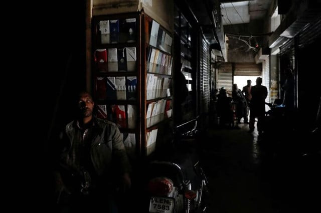 a man sits outside his shop during a country wide power breakdown in karachi pakistan january 23 2023 photo reuters a man sits outside his shop during a country wide power breakdown in karachi pakistan january 23 2023 photo reuters