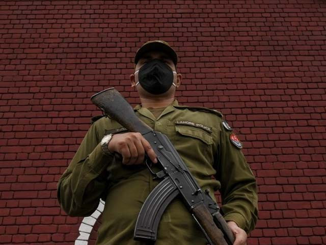 a policeman wearing a facemask stands guard in lahore photo afp a policeman wearing a facemask stands guard in lahore photo afp