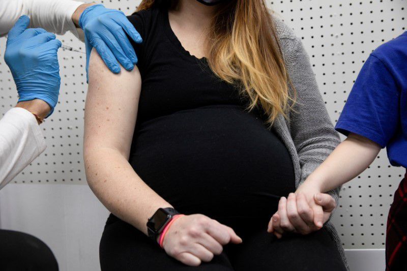 a pregnant woman receives a vaccine for the coronavirus disease covid 19 at skippack pharmacy in schwenksville pennsylvania us february 11 2021 photo reuters