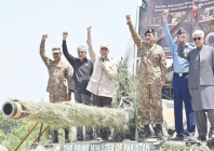 prime minister shehbaz sharif stands on a tank along with army chief general syed asim munir air chief marshal zaheer ahmed babar sidhu and his cabinet ministers during their visit at pasrur cantonment in sialkot photo ppi