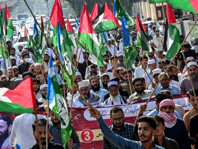 supporters of the jamaat e islami an islamist political party holding palestinian flags take part in an anti israel protest outside the us consulate in peshawar on october 3 2025 photo afp