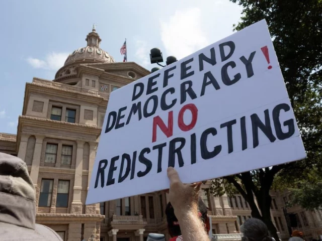 a protester raises a sign during one of the fight the trump takeover nationwide rallies against texas republicans efforts to redraw the state s 38 congressional districts at the state capitol in austin texas us august 16 2025 photo reuters a protester raises a sign during one of the fight the trump takeover nationwide rallies against texas republicans efforts to redraw the state s 38 congressional districts at the state capitol in austin texas us august 16 2025 photo reuters