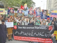 labour union activists hold placards and chant slogans during a protest against the us attack on venezuela in karachi on sunday photo afp